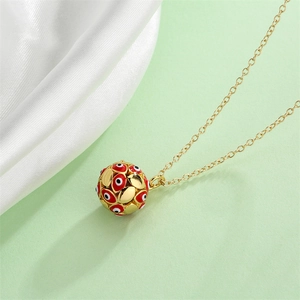 Detailed view of golden O-chain necklace featuring a red and black star eye hollow pendant