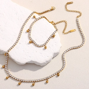 Detail view of 18K gold-plated stainless steel necklace and bracelet set with cubic zirconia