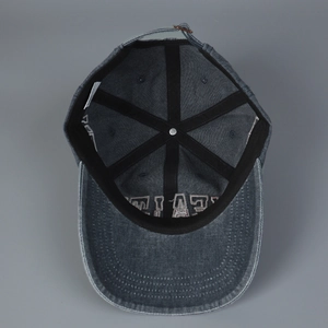 Interior view of vintage washed grey-blue baseball cap with reinforced stitching and metal buckle