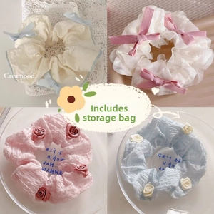 Detailed grid of cream-colored scrunchies with elegant ribbon bows and 3D floral accents