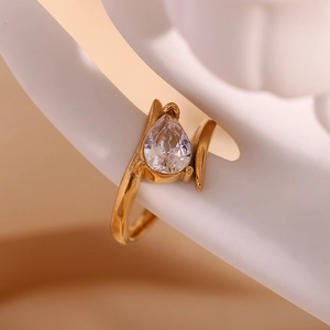 Detailed view of 18K gold plated wing ring featuring a teardrop zirconia on ceramic stand
