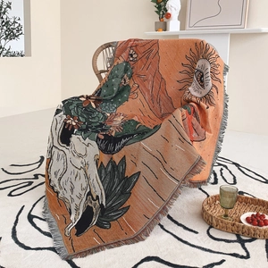 Detail of bohemian knit throw blanket featuring fringe edges and retro artistic patterns