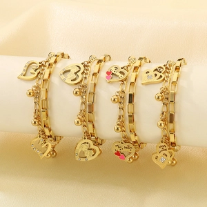 Close-up of golden double-layer heart bracelets with Mama and Mom engraved charms