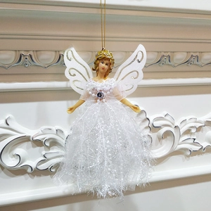 Close-up of white lace angel doll ornament with gold wings for Christmas tree decoration