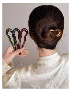 U-shaped hair pin for buns shown in amber, green, black and deep red acrylic resin