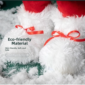Detailed view of red and white Christmas boot decoration with a satin bow on snow