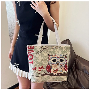Detailed view of an ethnic canvas tote bag with colorful owl embroidery and LOVE text