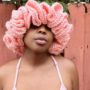 Pink oversized ruffled knit beanie with crochet ruffle brim for women in boho street style