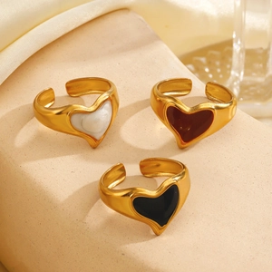 Vintage 18K gold plated heart rings with colorful enamel inlays on stone display