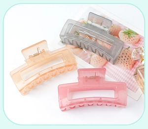Close-up of translucent jelly square hair claws in smoky grey and pink hues