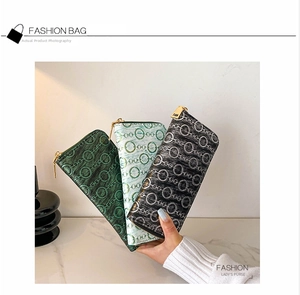 Detail view of long PU leather wallets with vintage chain patterns and golden zippers