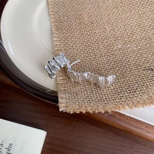 Minimalist 925 sterling silver irregular crumpled earrings on textured rustic linen fabric