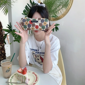 Floral corduroy pencil case with merci paris logo shown in a cozy lifestyle setting