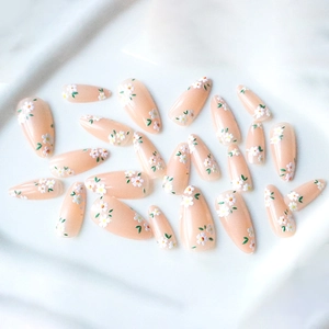 Almond press-on nails with white daisies and green leaves on jelly pink base
