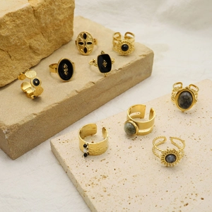 Adjustable gold stainless steel rings with black and grey natural stones on stone base