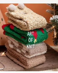 Detail of stacked Christmas coral fleece socks in beige, green and brown with festive patterns