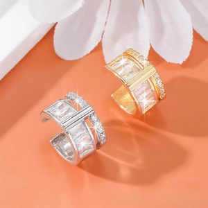 Detail of wide C-shape ear cuffs with rectangular zircons in gold and silver plating