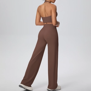 Macro detail of chocolate brown halter yoga top and high-waisted wide leg fitness pants