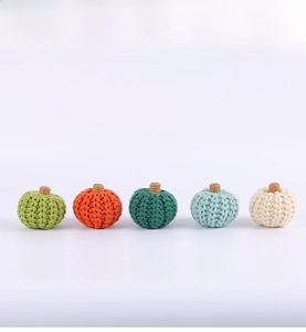Detailed texture of five colorful knitted pumpkins for autumn home decor and party layout