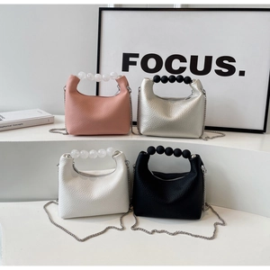 Detailed display of mini Hobo bags in four colors with pearl handles and metal chains