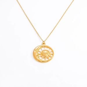 Close-up of 18k gold plated sun and moon cutout pendant on a delicate cable chain