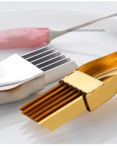 Close-up of golden and silver stainless steel green onion slicer with multiple sharp blades