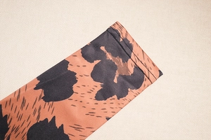 Close-up of leopard print dress sleeve showing knit fabric texture and high-quality stitching
