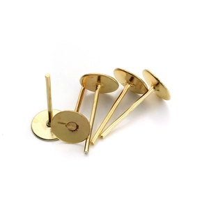 Macro shot of gold-plated flat pad earring studs for DIY jewelry making and craft supplies