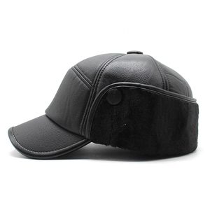 Detail view of winter ear flap baseball cap showing black faux leather and warm fur lining