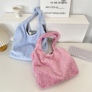 Detail view of leopard print plush tote bags with black and white checkered lining