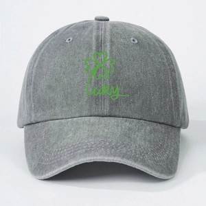 Detail of grey washed denim baseball cap with green lucky clover print and stitching