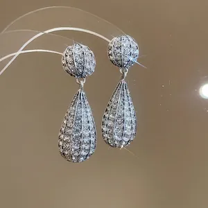 Silver drop earrings featuring sparkling rhinestones and a teardrop-shaped pendant design