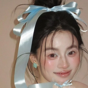 Long blue satin bow hair clip for women with elegant silk texture and flowing ribbons