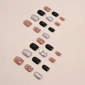 Short square press-on nails in black, pink, and silver glitter with star patterns