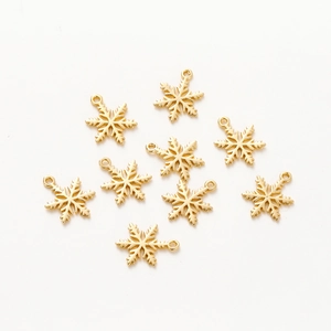 Detailed view of nine 18K gold-plated snowflake charms for DIY jewelry making crafts