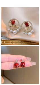 Detail of red rose earrings with pearl accents and sparkling crystal border on silk