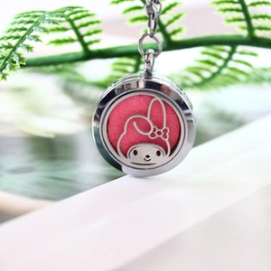 Close-up of hollow bunny pendant on green plant featuring pink aroma cotton pad insert
