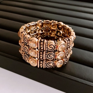 Detailed view of rose gold multi-layer elastic bracelet with champagne rhinestones