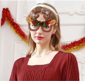 Close-up of glittery reindeer antler glasses with white snowflakes and festive ornaments