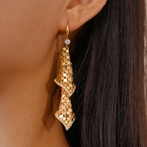 Detailed close-up of 18k gold plated spiral mesh drop earrings with zircon embellishments