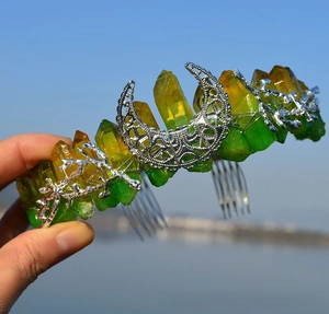 Detail of bohemian cat ear crystal crown featuring moon accents and green-yellow gradient