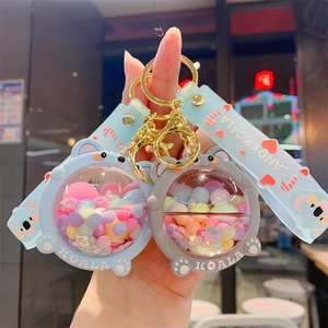 Cute liquid shaker koala keychain with silicone wristband and glitter accents in two colors