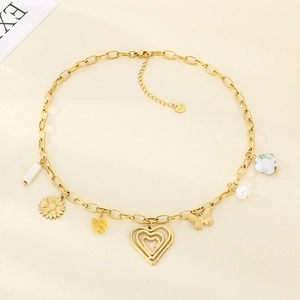 Detailed view of golden stainless steel necklace with heart and butterfly charms