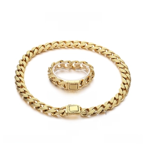 Detailed macro view of the embossed texture on golden stainless steel Cuban link jewelry set