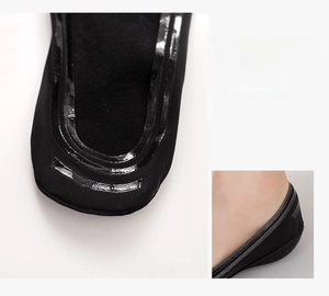 Detail view of non-slip silicone heel grips on black low-cut ice silk invisible socks