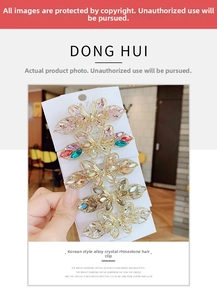 Detailed view of five crystal butterfly hair clips in various colors held in hand