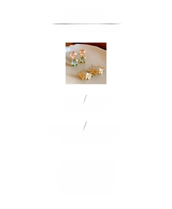 Macro view of flower earrings with pink and blue enamel petals and pearl details