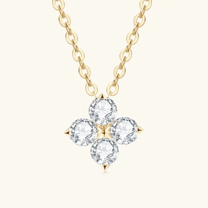Close-up of heart-shaped clover pendant with brilliant cut white moissanite in gold