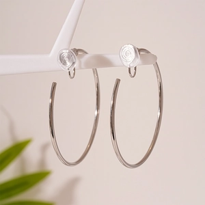 Detail showing the adjustable clip-on mechanism with soft padding on silver loop earrings