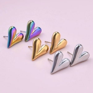 Polished 3D heart-shaped stud earrings in iridescent, gold, and silver finishes